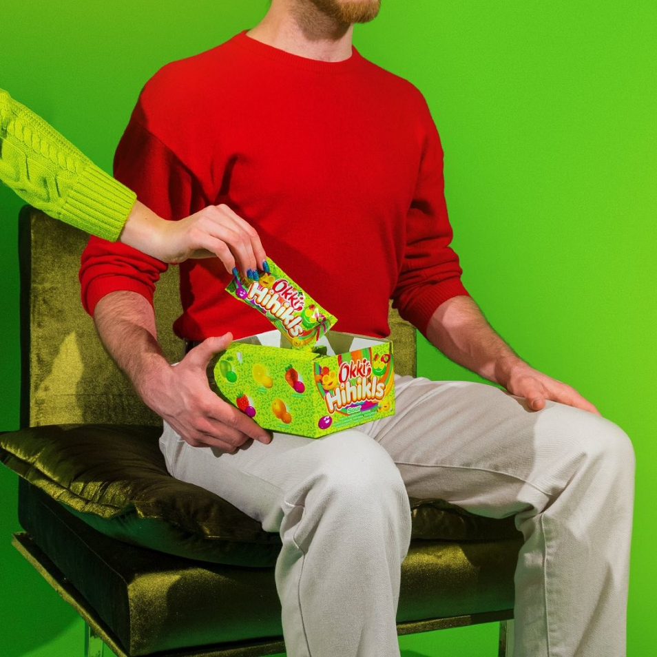 Model holding a box of Okki candy