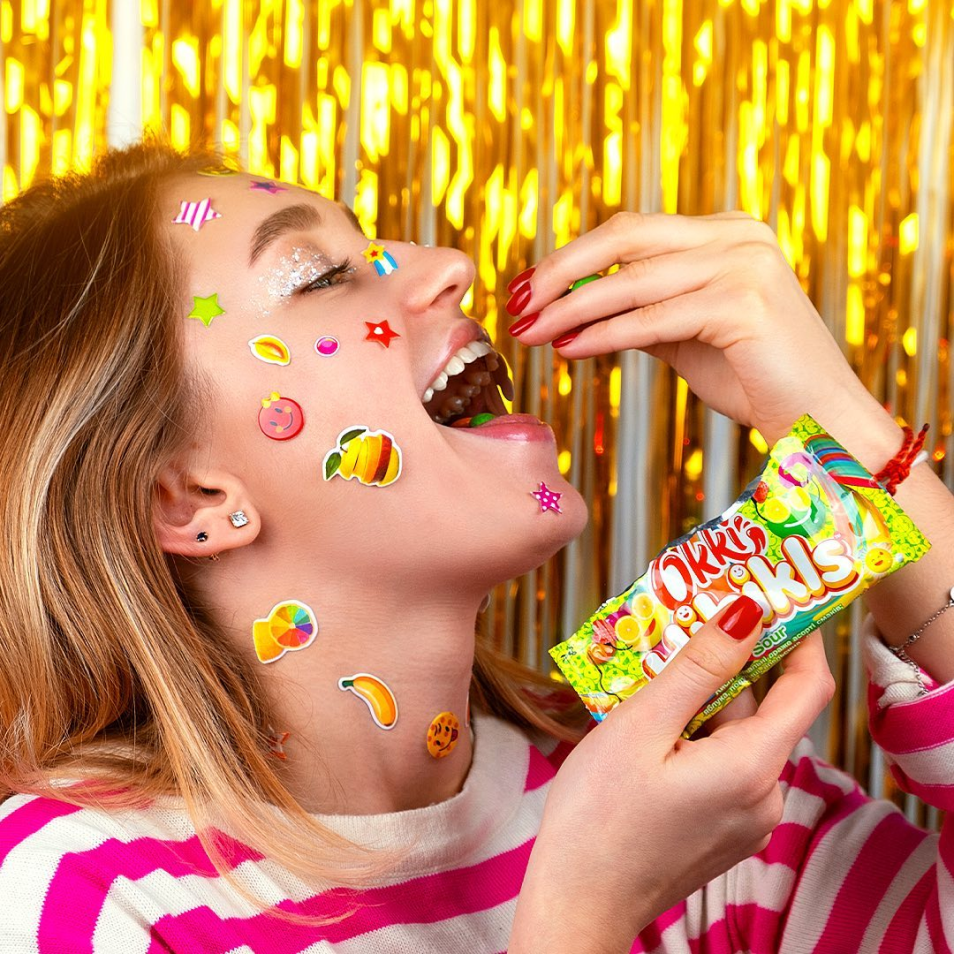 Model enjoying Okki candy